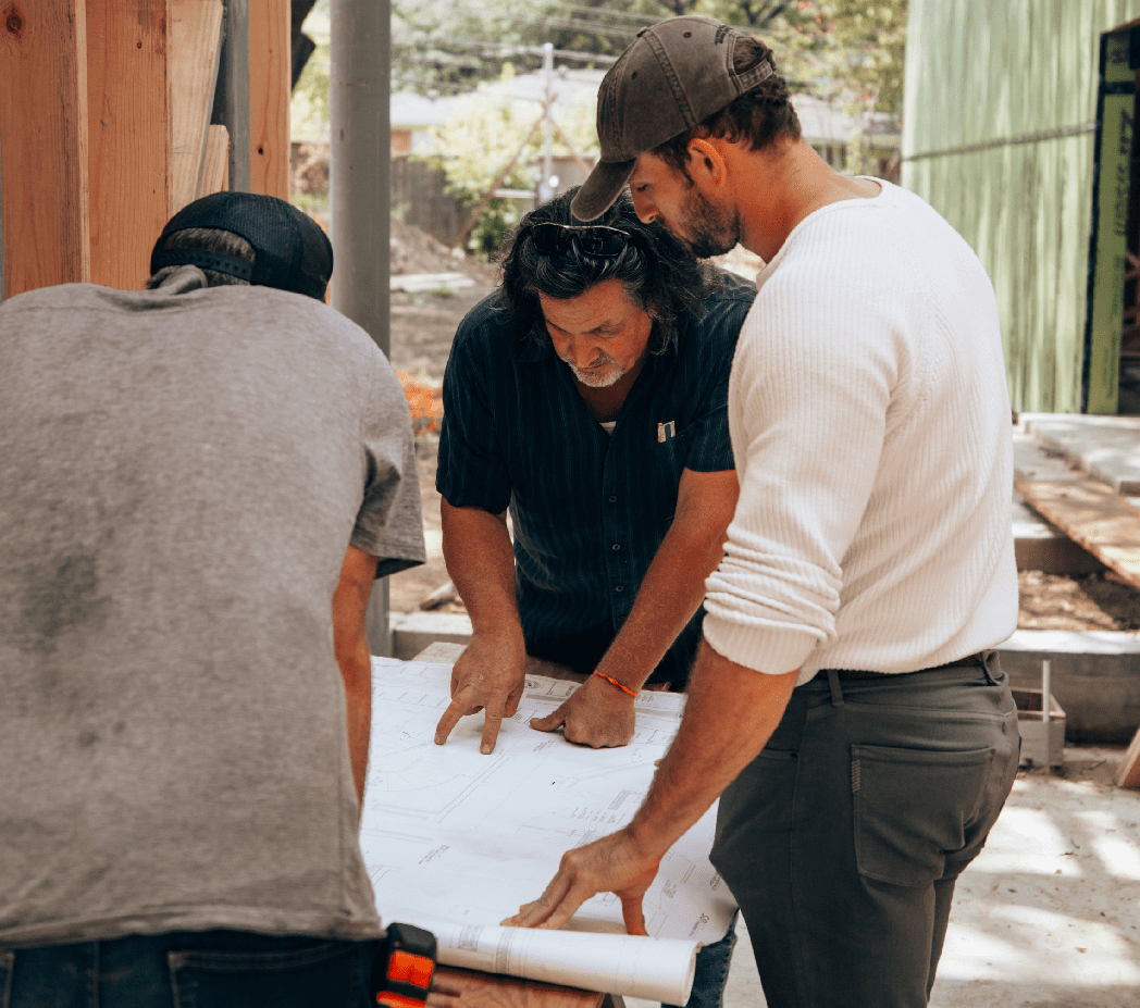 Clerk of the works reviewing construction plans on site