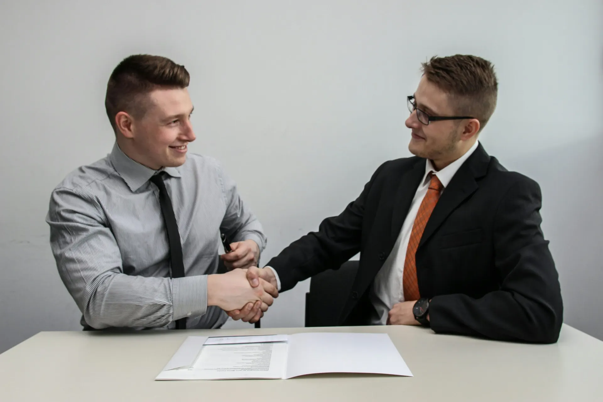 Construction consultants reviewing building codes and shaking hands