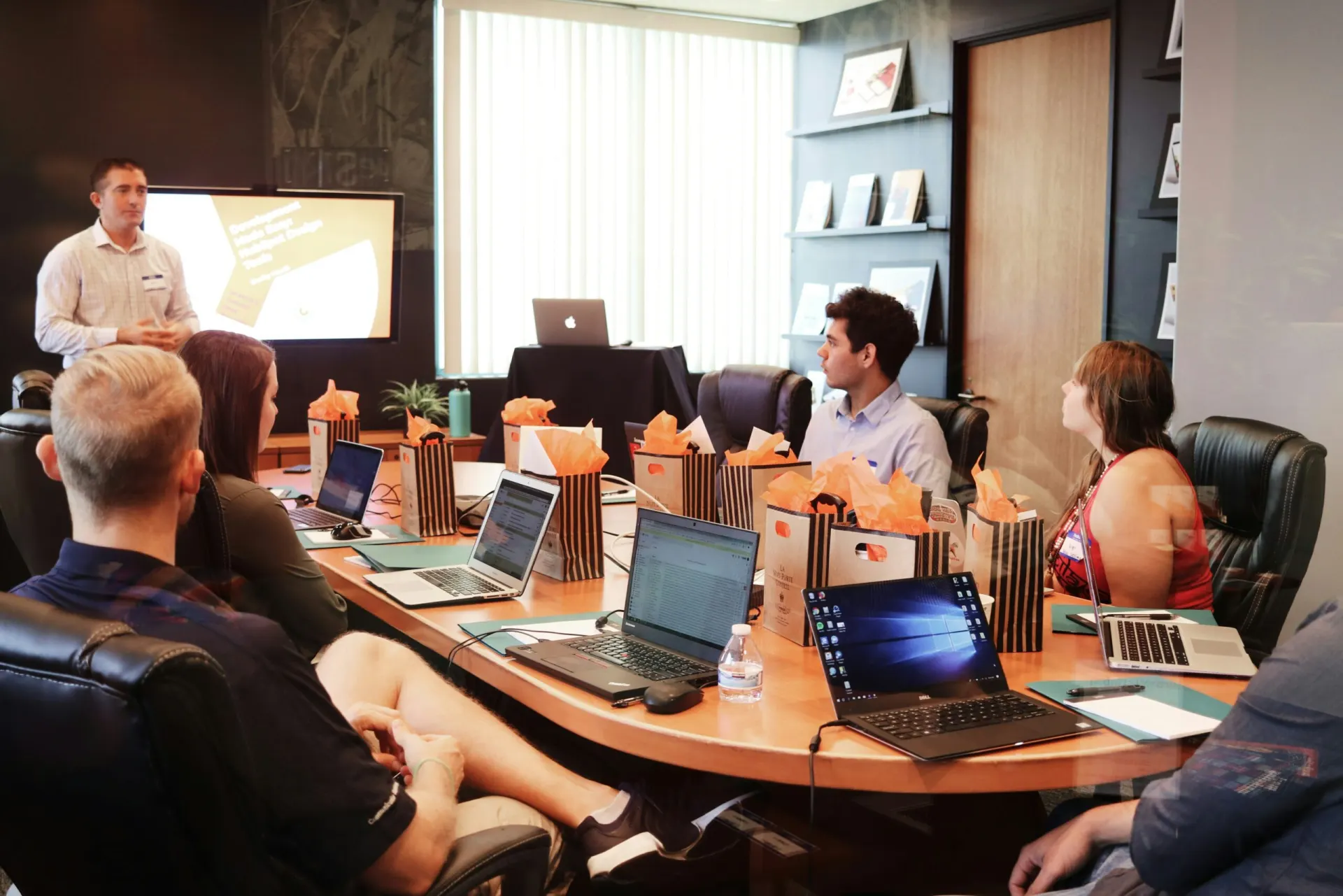 Team around a table while the owner representative shares information